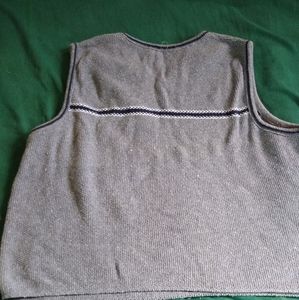 Grey sweater vest with a stripe accent.